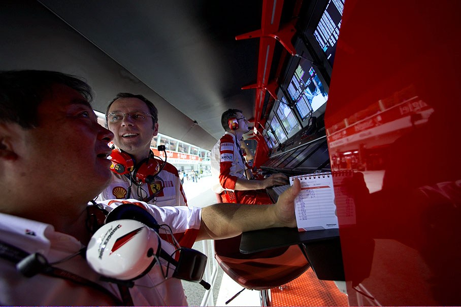 Team principal Stefano Domenicali speaks with Hirohide Hamashima of Bridgestone at Ferrari's pitwall command center