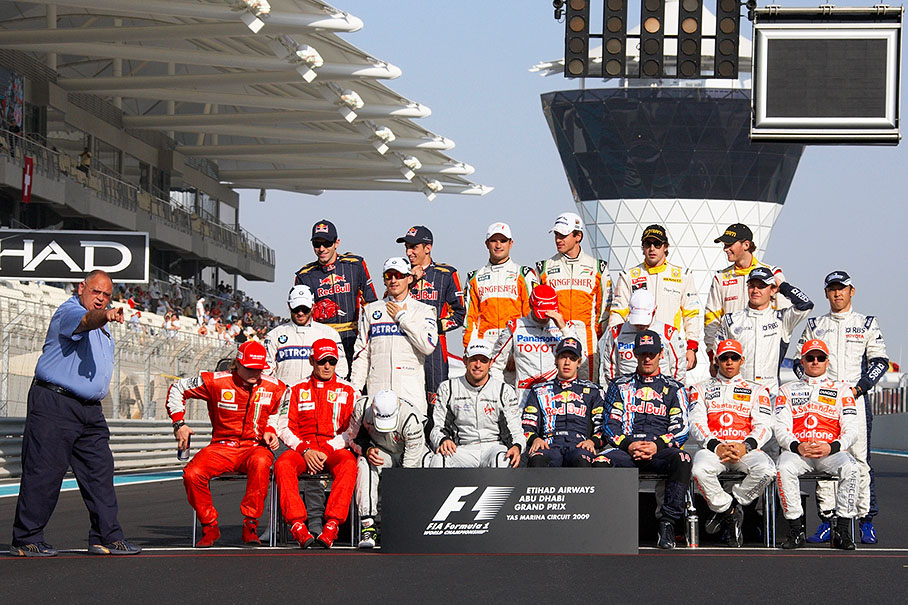 Pat Behar, the FIA photographer's delegate, delegates the photographers before the drivers group photo
