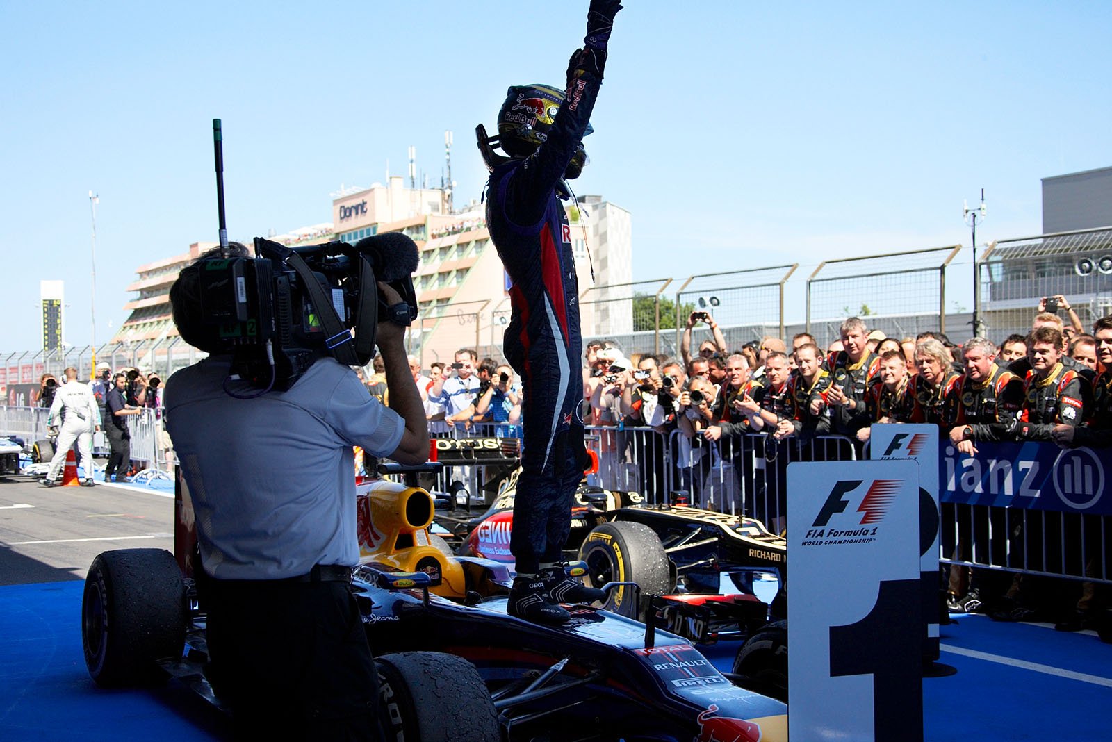 Race winner Sebastian Vettel of Red Bull Racing celebrates in parc ferme and jumps on his race car 'Hungry Heidi'