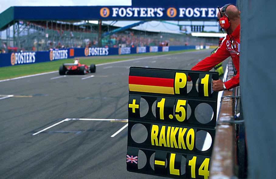 Ferrari mechanic signaling from pitwall