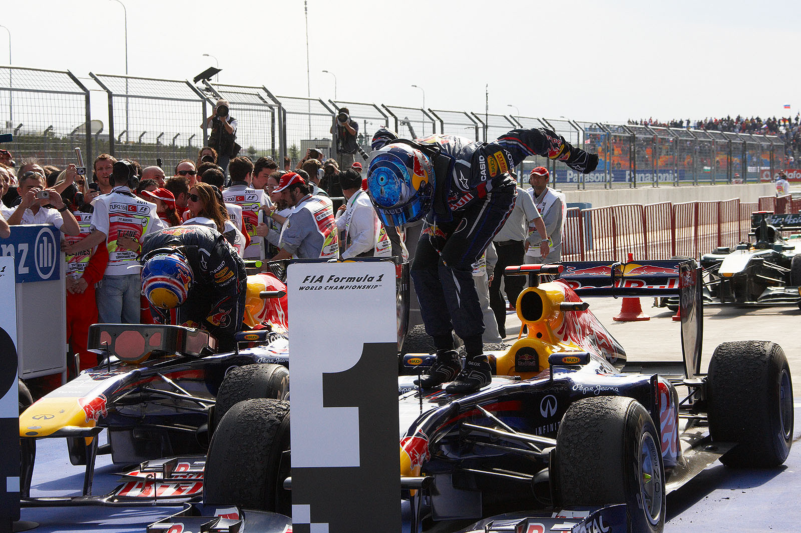Again winning 1-2, the victorious Red Bulls Mark Webber and winner Seb Vettel get out of their cars in parc ferme in their personal manner