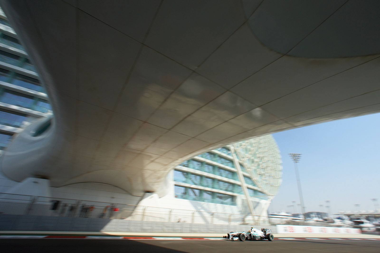 Lewis Hamilton, Mercedes, passes the steel and glas bridge at the Yas Viceroy Abu Dhabi Hotel