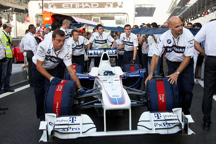 On Sunday before the race, BMW Sauber mechanics push their car from scutineering to pits for the last time