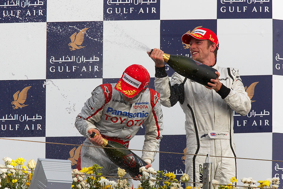 Happy winner Jenson Button sprays champagne after podium ceremony