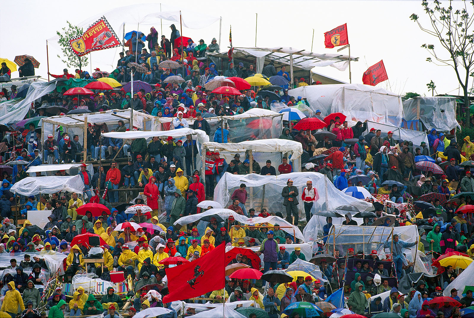 The tifosi on Imola's fan hill build shelters against the rain