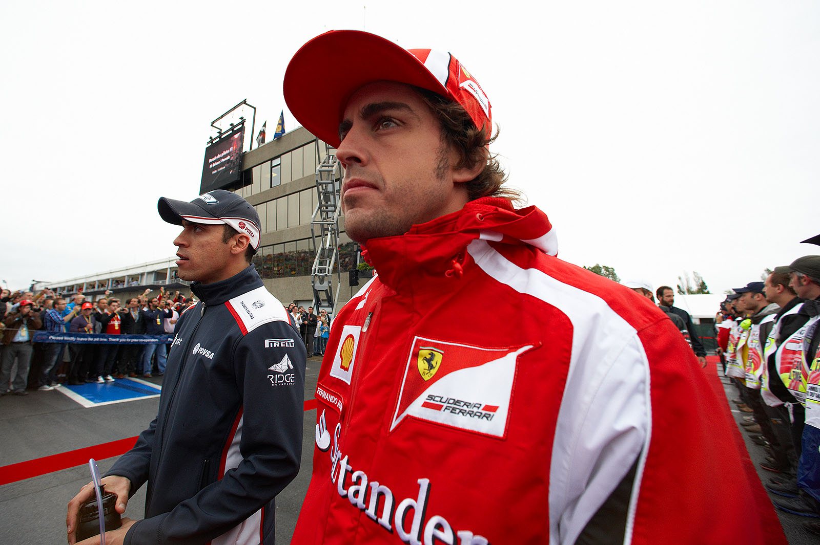 Fernando Alonso walks to drivers parade with Pastor Maldonado