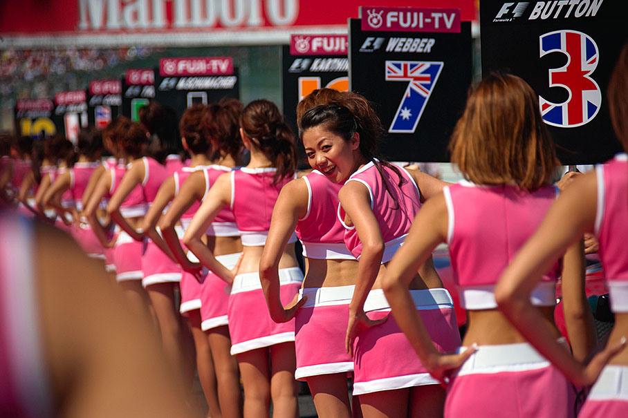 A long row of Japanese grid girls - Webbers girl smiling promisingly at the snappers.