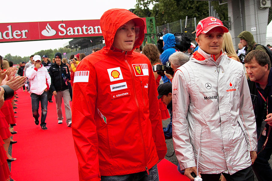 The two Finns Kimi Raikkonen and Heikki Kovalainen walk to drivers parade