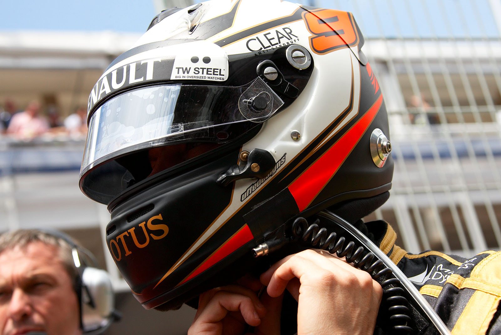 Kimi Raikkonen of Lotus puts his helmet on before the race