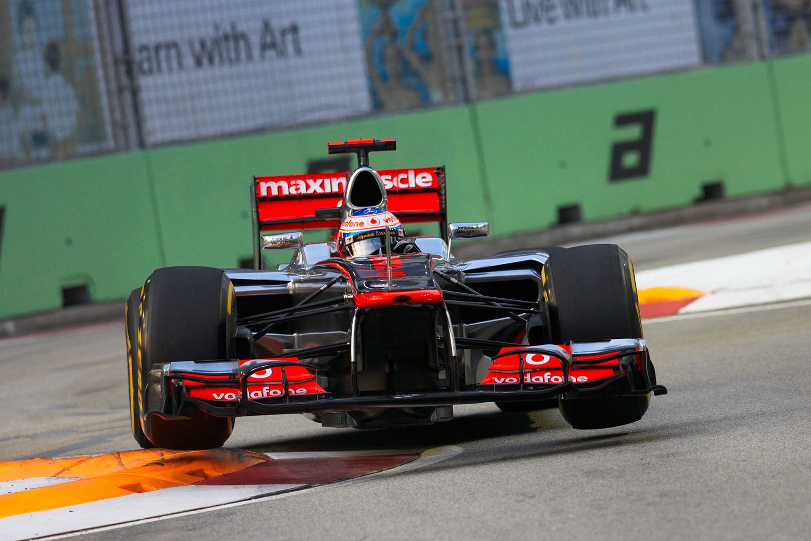 Jenson Button, McLaren Mercedes, jumps over the curbs