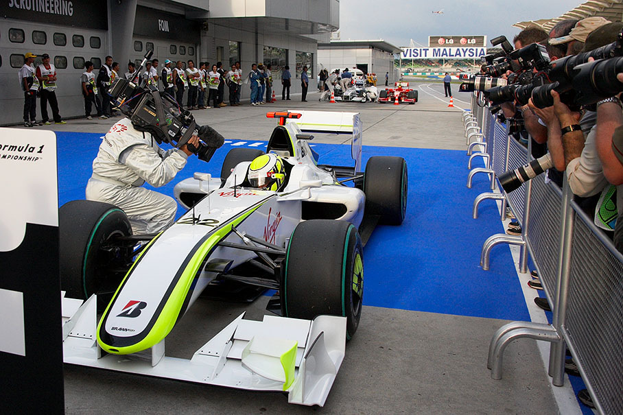 Jenson Button arrives at parc ferme after gaining second pole position in a row