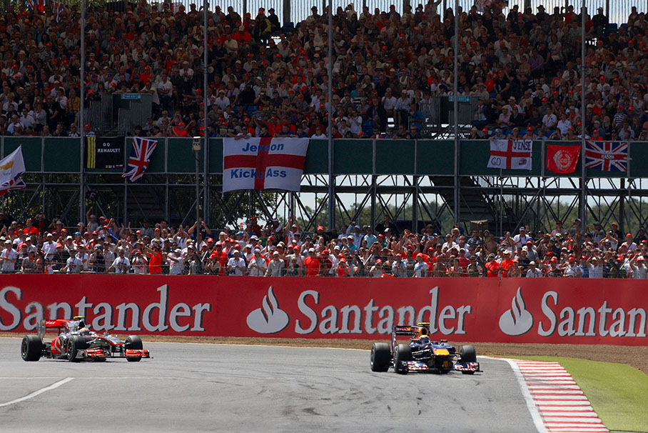 Mark Webber, Red Bull Racing and Lewis Hamilton, McLaren Mercedes, in front of filled-up grand stands