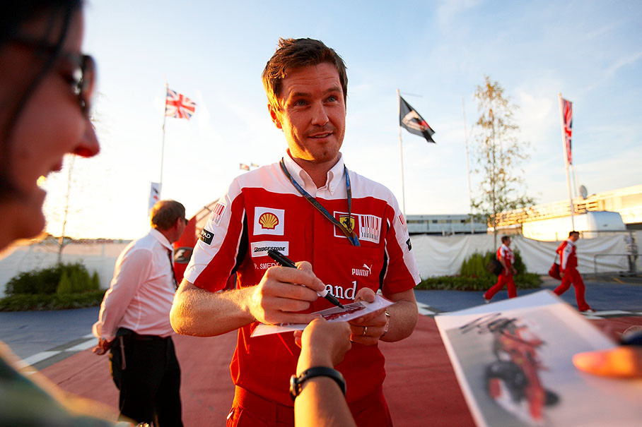 Felipe Massa's race engineer at Ferrari, Rob Smedley, gives autographs to waiting fans in front of the paddock on Thursday evening