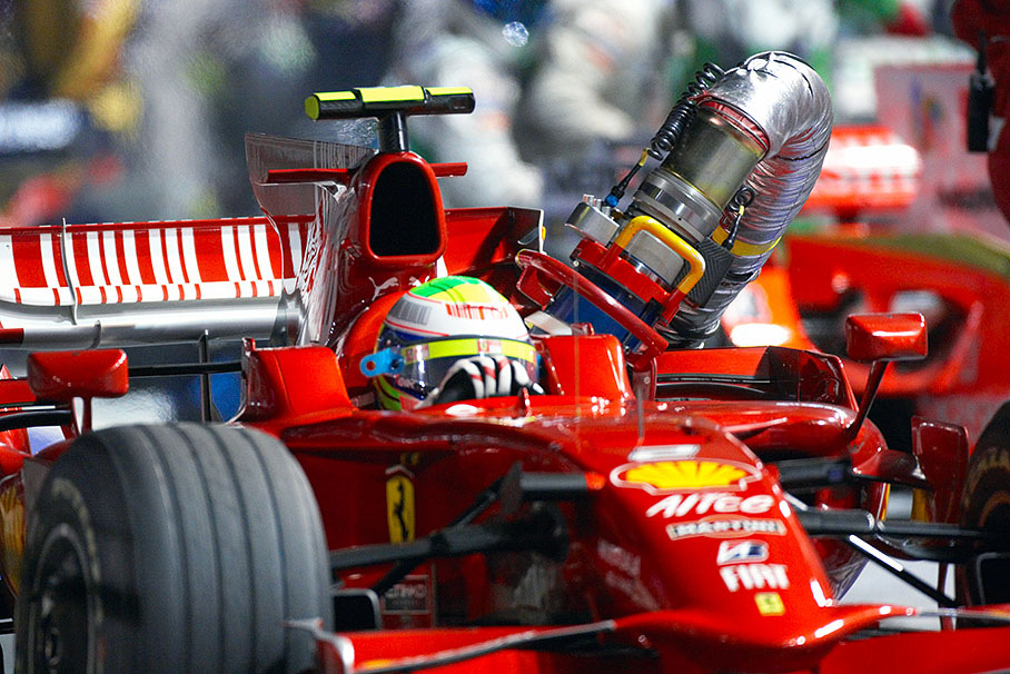 After Massa's pit stop the refueling nozzle is still stuck in the tank of the Ferrari car