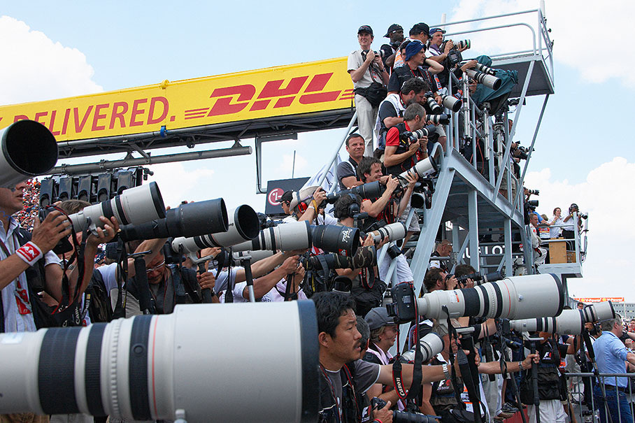 Heavily equipped photographers wait for the podium ceremony