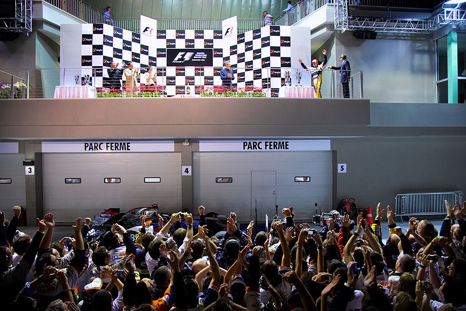 Winner Fernando Alonso cheers at the waving arms from the top of the rostrum