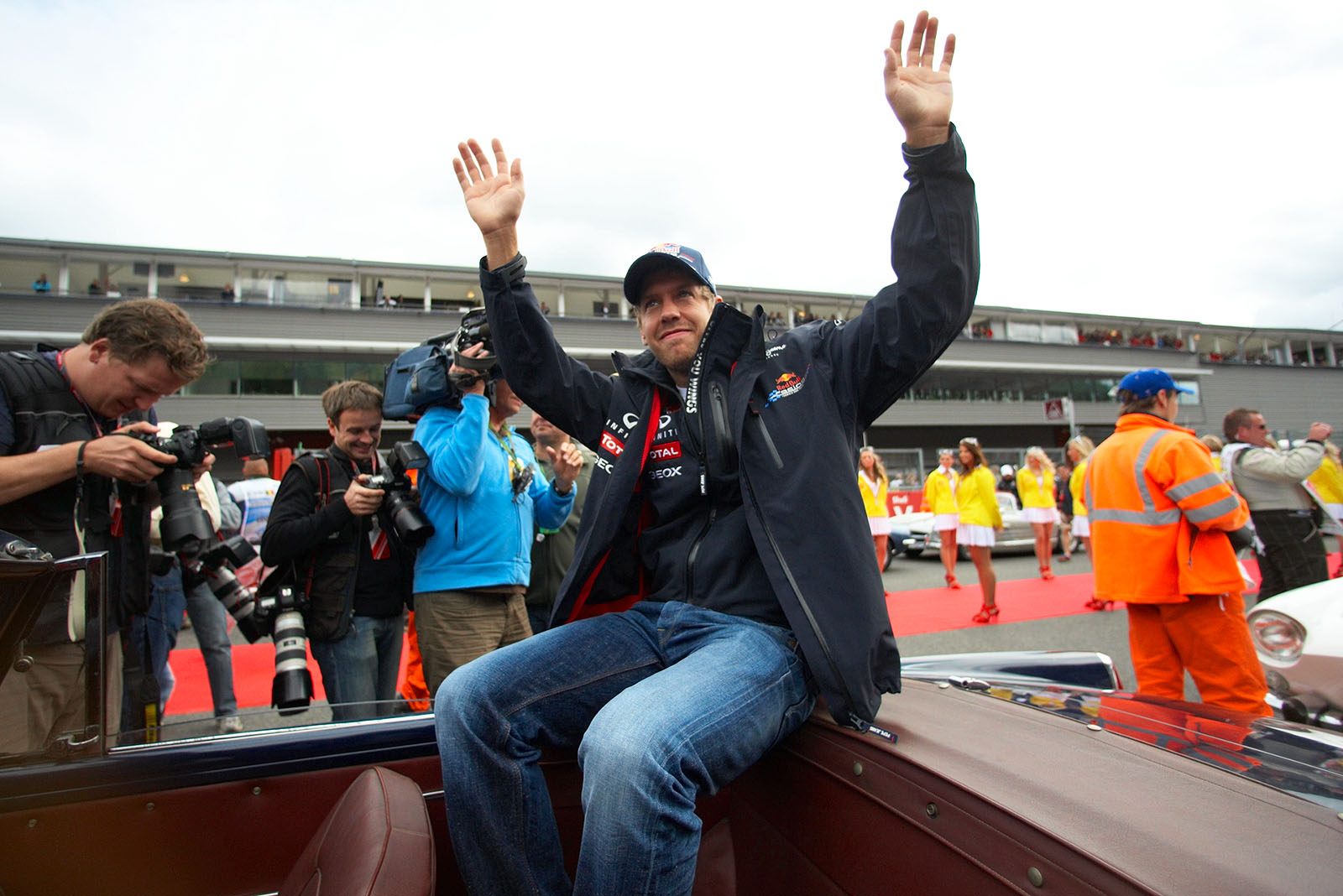 Sebastian Vettel, Red Bull Racing, greets the fans during drivers parade - and the busy fellow photographers check their achievements