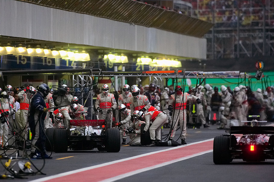The McLaren pit crew acclaims Hamilton to a fast tyre exchange