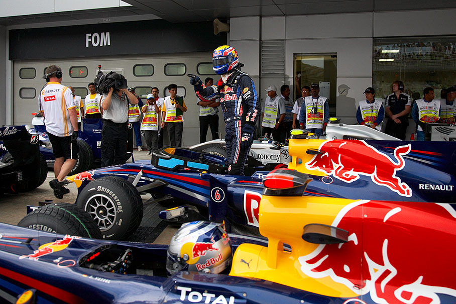 Polesetter Mark Webber stands in his Red Bull-Renault in parc ferme, besides him just arriving his team mate Vettel and Mercedes GP's Nico Rosberg at the back