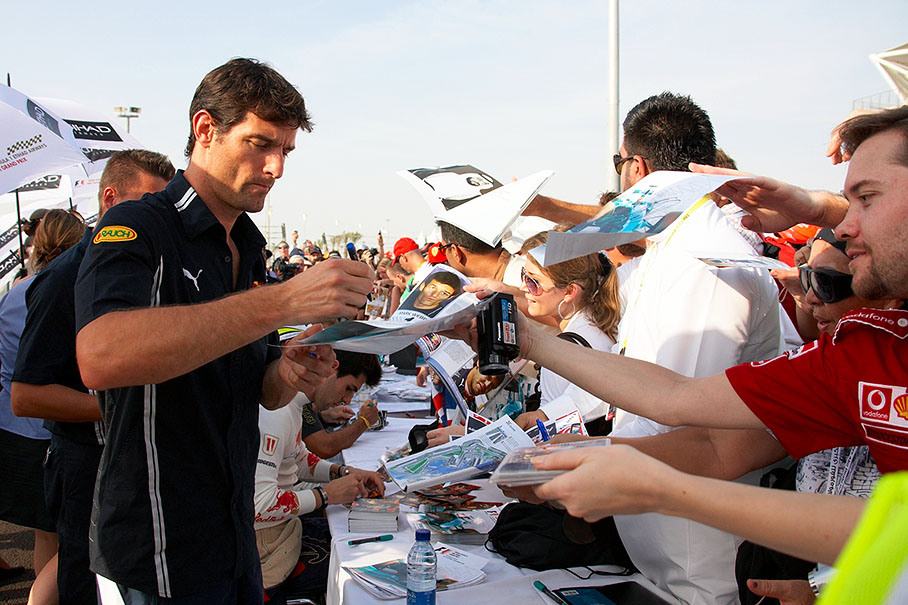 Red Bull ace Mark Webber gives away autographs