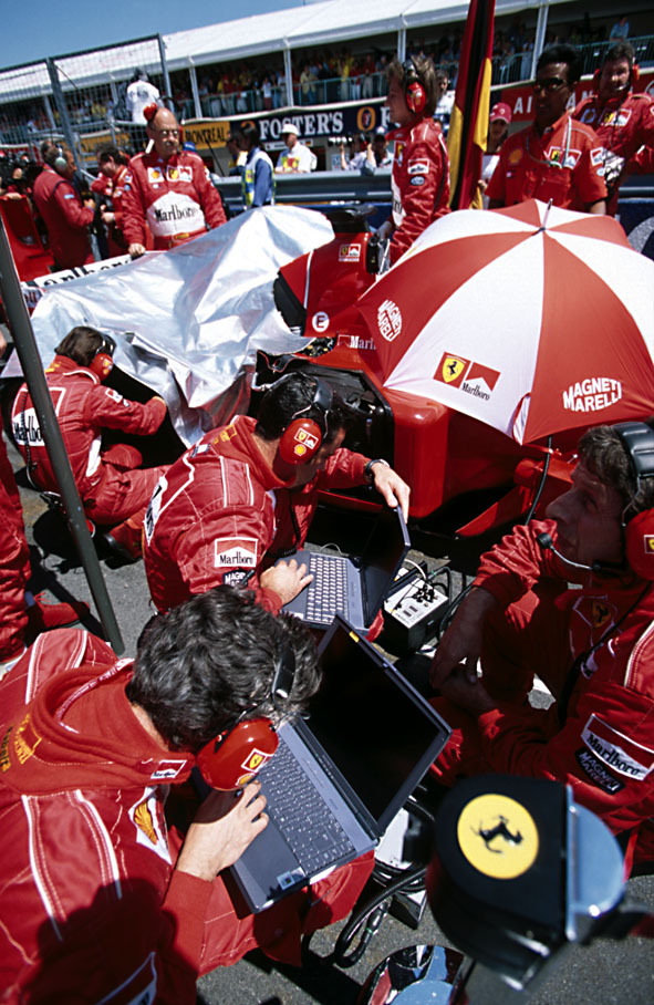 Ferrari mechanics at work on the grid