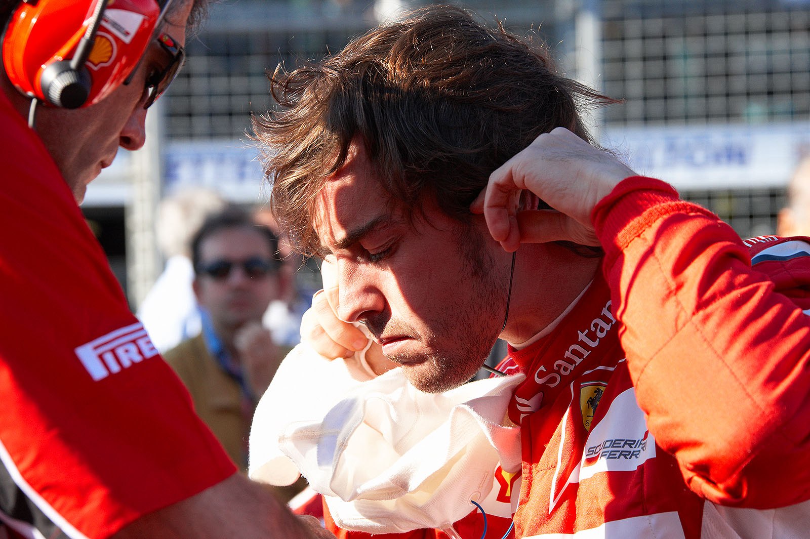Fernando Alonso, Ferrari, takes his earphones out on his grid position