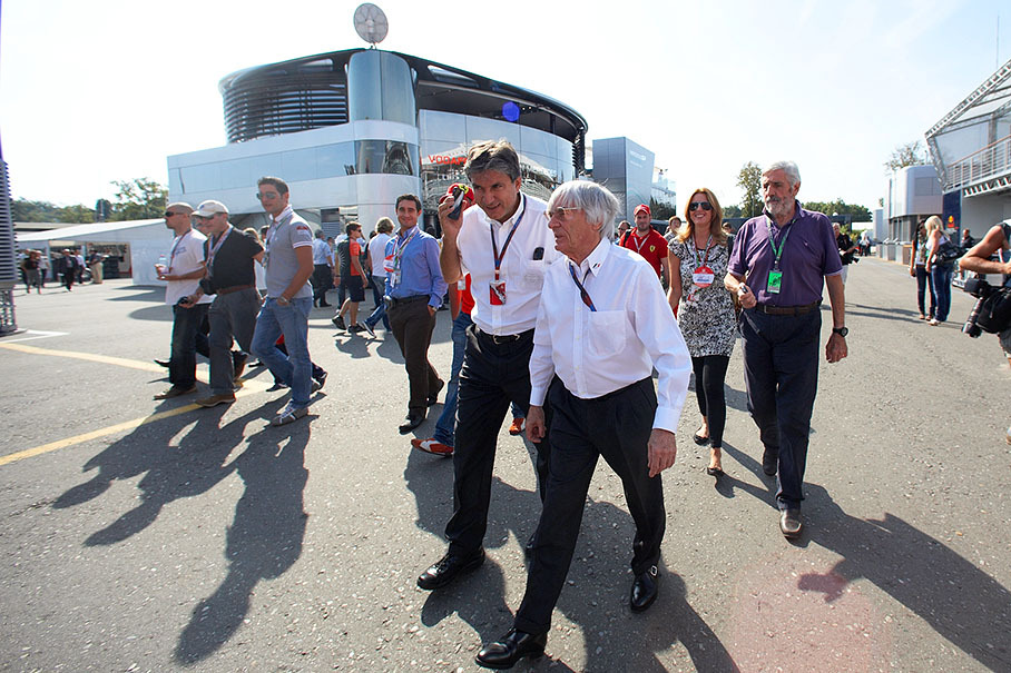 Formula One godfather Bernie Ecclestone walks through the paddock with his secretary