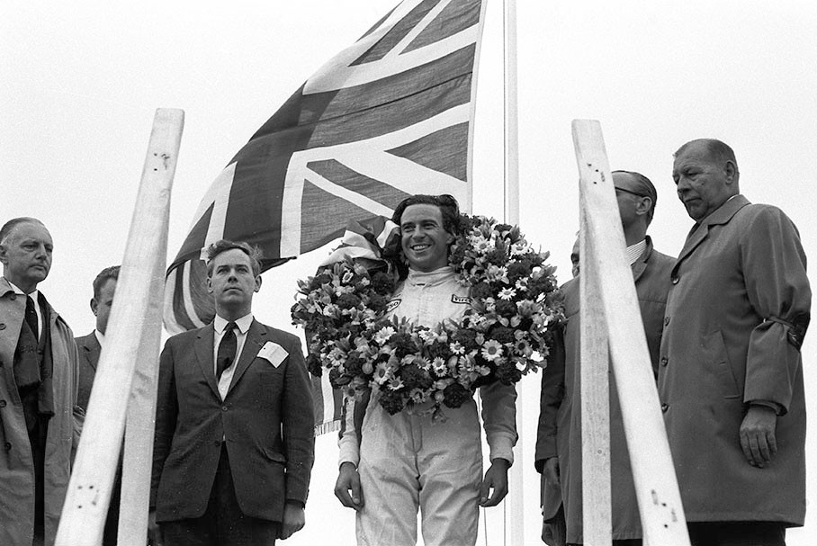 Race winner Jim Clark on the podium besides Keith Duckworth, constructor of the successful Cosworth engine.