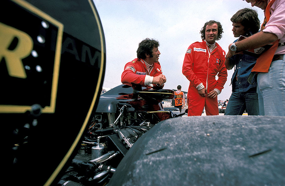 Gunnar Nilsson and Mario Andretti loosely chatting with journalists