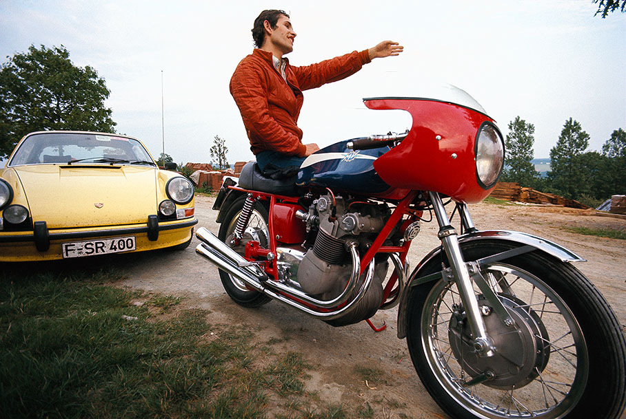 Jacky Ickx with his private motorcycle (Rainer's Porsche 911 in the background) after the Belgium GP 1972