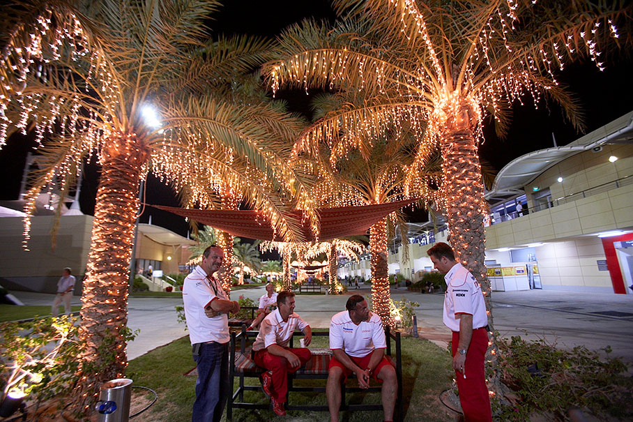 Illuminated palm trees create a festal paddock atmosphere