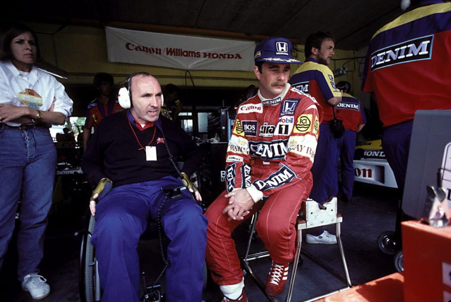 Nigel Mansell watches practice times with his team boss Frank Williams
