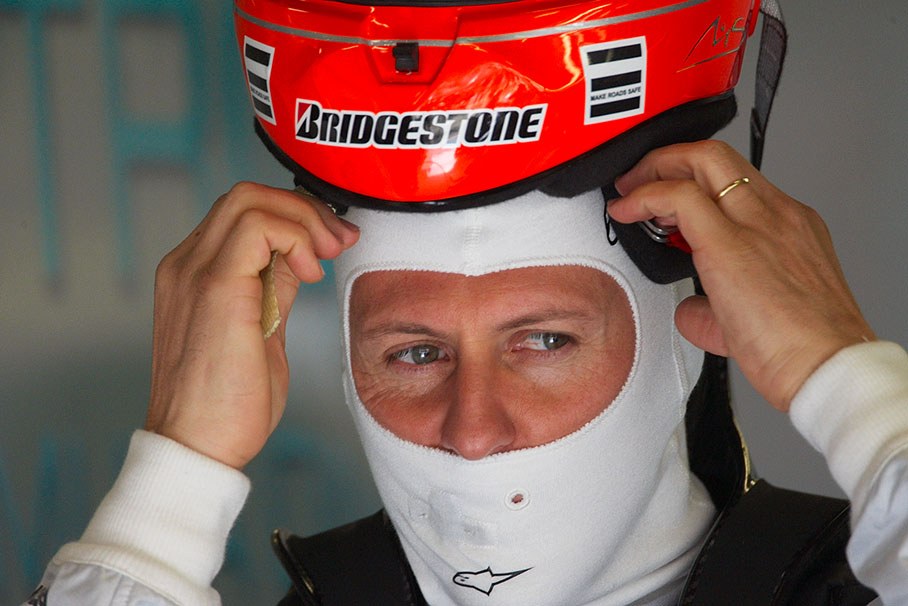 Michael Schumacher puts his helmet on in Mercedes GP pits