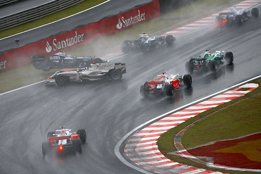 Coulthard slides backwards through the field of competitors and crashes with Nakajima
