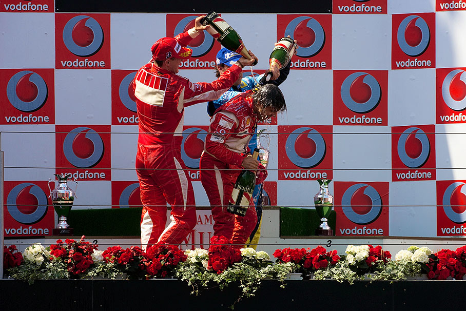 Michael Schumacher and Fernando Alonso baste Felipe Massa with champagne