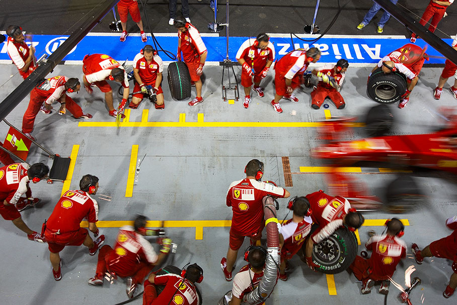 Ferrari mechanics practise pit stops on Thursday evening