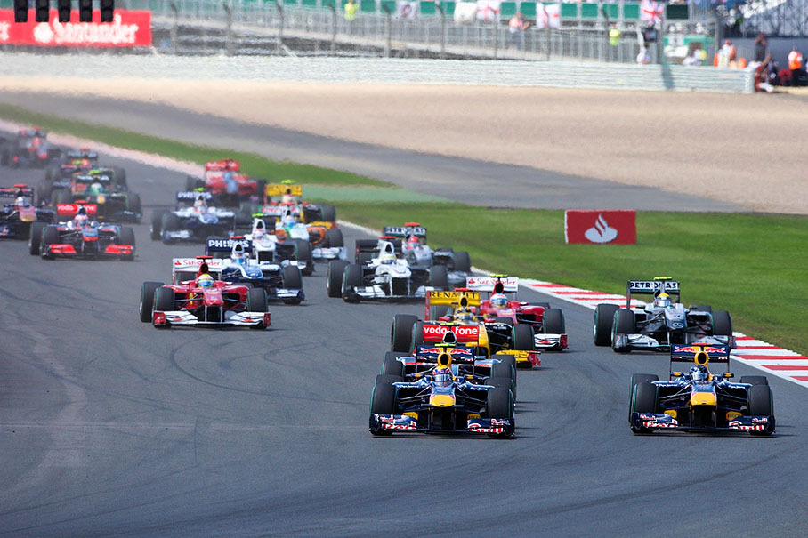 After the start, Red Bull team mates Webber and Vettel come wheel-to-wheel to turn one