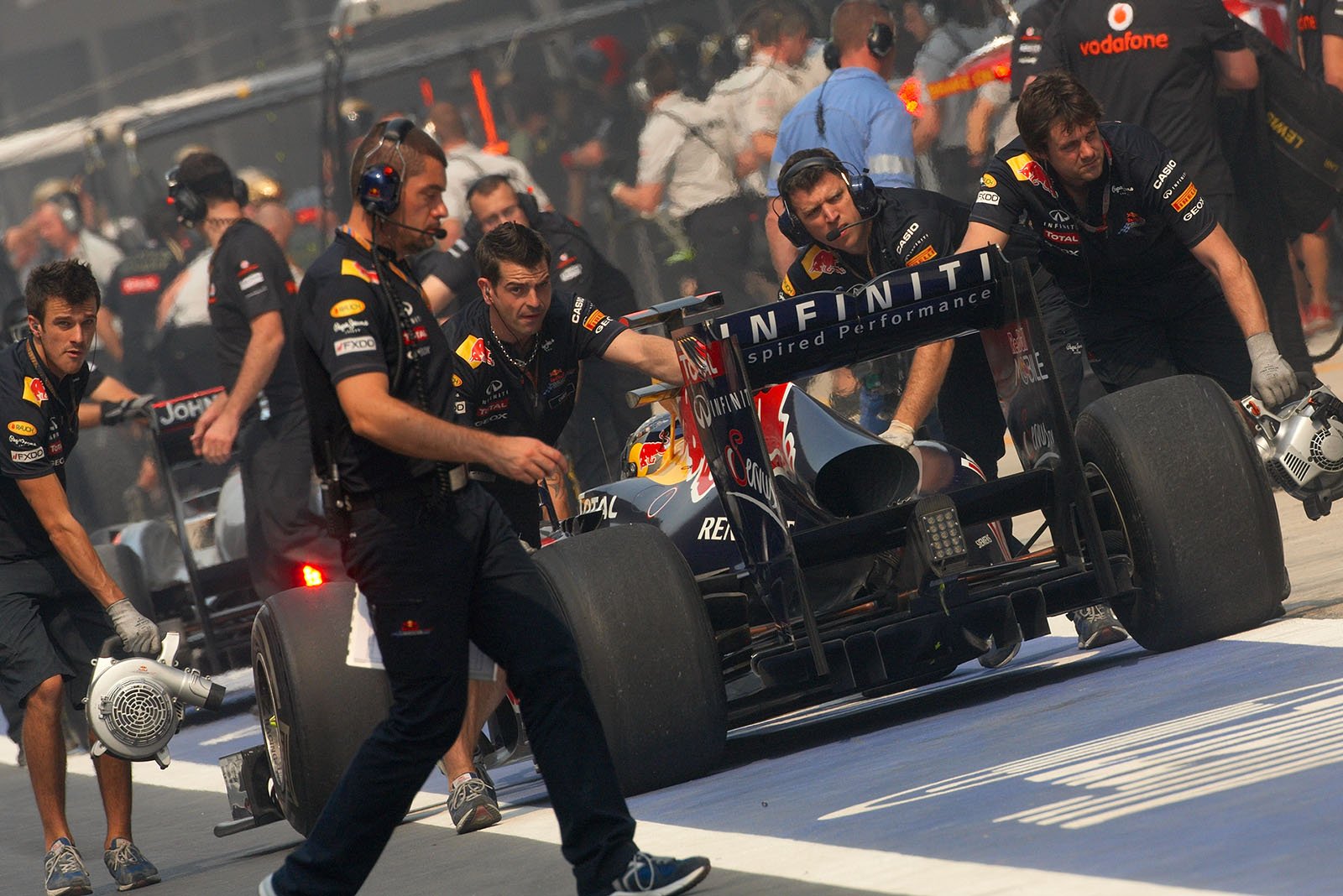 Sebastian Vettel is pushed backwards to pits during the qualifying pit stops by the Red Bull mechanics
