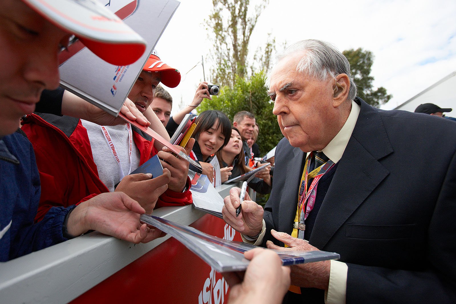 Australian gentleman driver legend 'Black Jack' Brabham gives autographs to the true fans