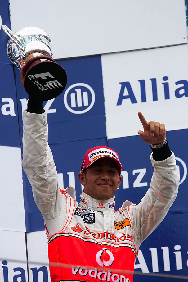 Thirs placed happy Lewis Hamilton presents his trophy