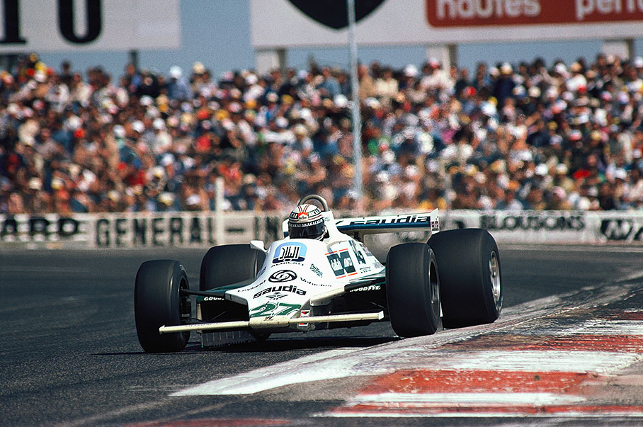 Williams-Ford FW07B driver Alan Jones (AUS) comes down the finishing straight. The skirt beneath the car can be seen.