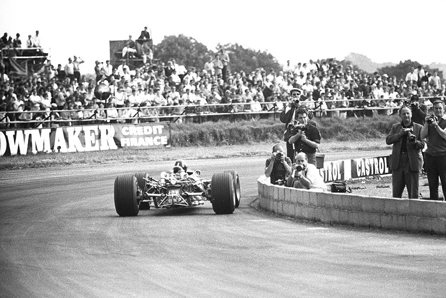 Graham Hill on Lotus-Cosworth 49 passes alert photographers