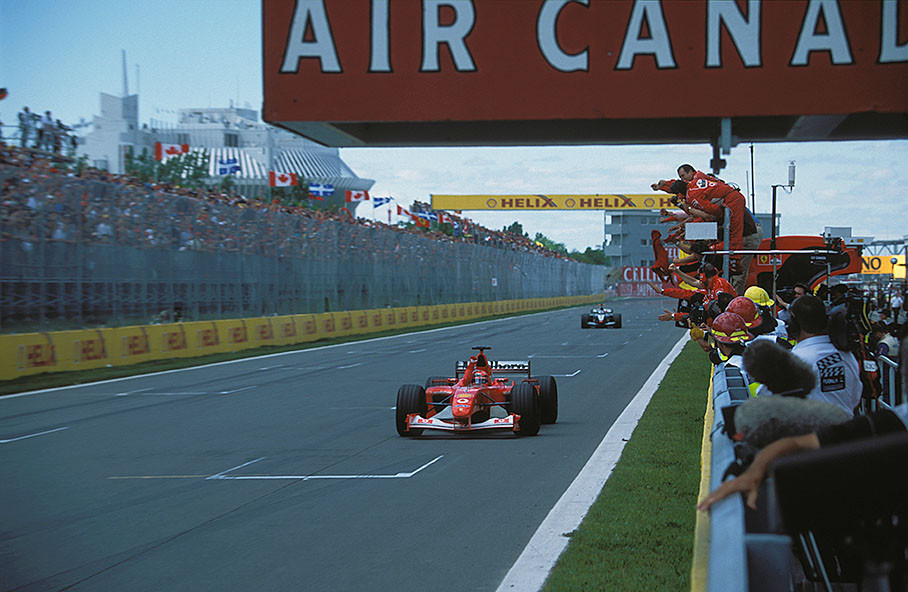 Michael Schumacher passing his cheering team