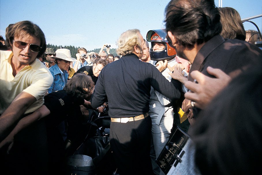 Winner Emerson Fittipaldi returns to Lotus team boss Chapman through the crowds after the Austrian GP 1972