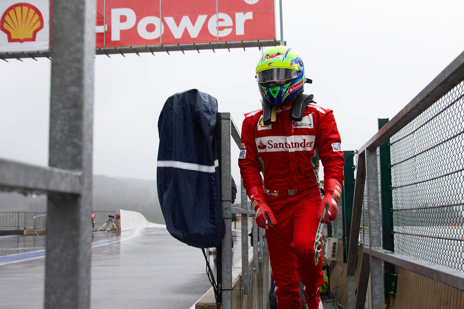 Felipe Massa, Ferrari, ends a rainy session with a walk back to pits