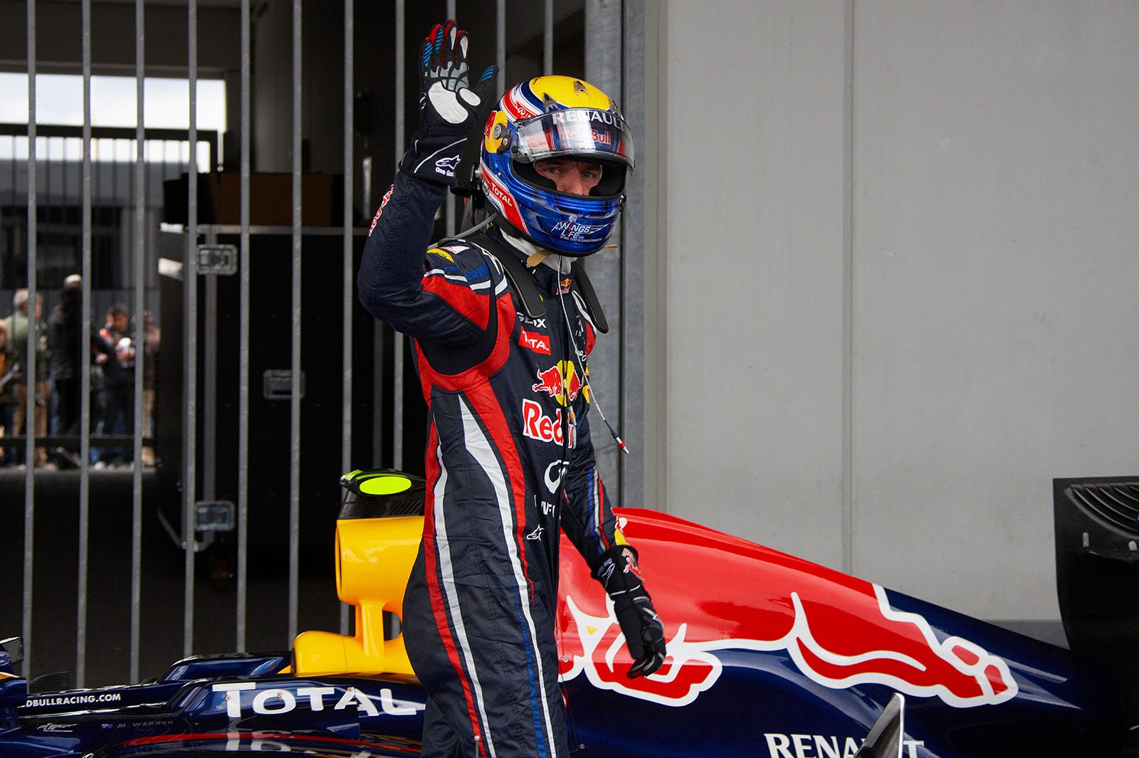 After qualifying, polesetter Mark Webber waves for the media in parc ferme
