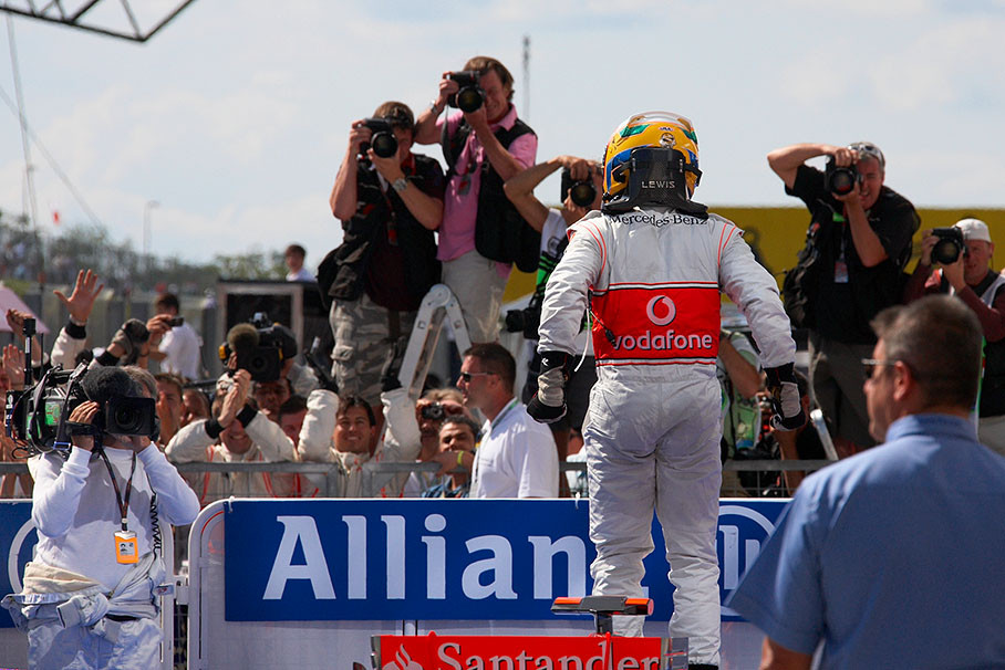 Race winner Lewis Hamilton jumps on his car in parc ferme