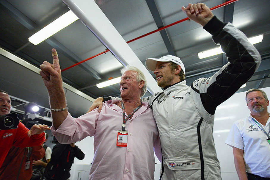 John and Jenson Button still cheer in the Brawn GP pits long after race end