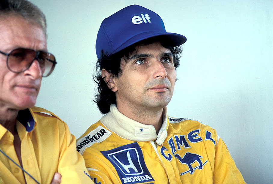 Nelson Piquet besides Peter Warr in Lotus pits