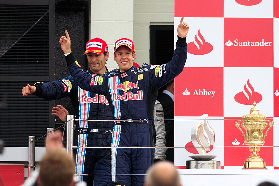 Race winner Sebastian Vettel and his second placed team mate Mark Webber appear on Silverstone's podium